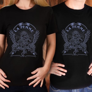 May include: Two black t-shirts with a graphic design of a snake wrapped around a rose with wings and the text "LA FEMME".