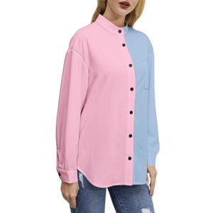 May include: A long-sleeved button-down shirt in a color-block design. The shirt is split vertically, with the left side in pink and the right side in light blue. It features a mandarin collar and black buttons.