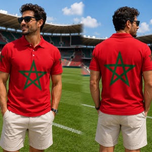 May include: Red polo shirt with a green star design on the front and back. The shirt has short sleeves and a button-up collar. The person is wearing khaki shorts and sunglasses. The background is a green field and a stadium.
