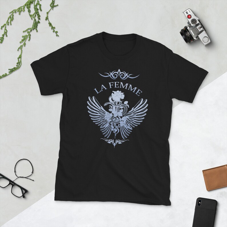 May include: Black t-shirt with a white graphic design featuring a rose, snake, and wings. The text "LA FEMME" is above the graphic.