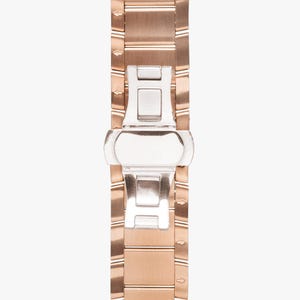 May include: Close-up of a rose gold watch band with a silver clasp. The band is made of rectangular links with a brushed finish. The clasp is a butterfly style, with a polished silver finish. The watch band is a stylish accessory.