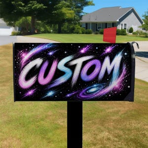 May include: A rectangular metal mailbox featuring a black background with a vibrant space-themed design. The word CUSTOM is written in large, stylized brushstroke lettering in shades of pink, blue, and white, surrounded by stars and a galaxy.