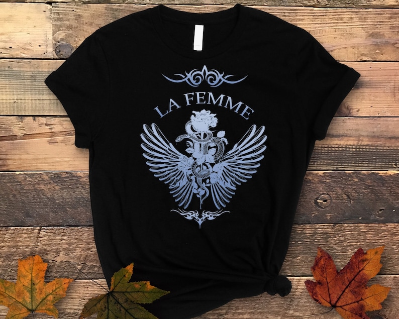 May include: Black t-shirt with a blue graphic design featuring a snake wrapped around a rose with wings and the text "LA FEMME".