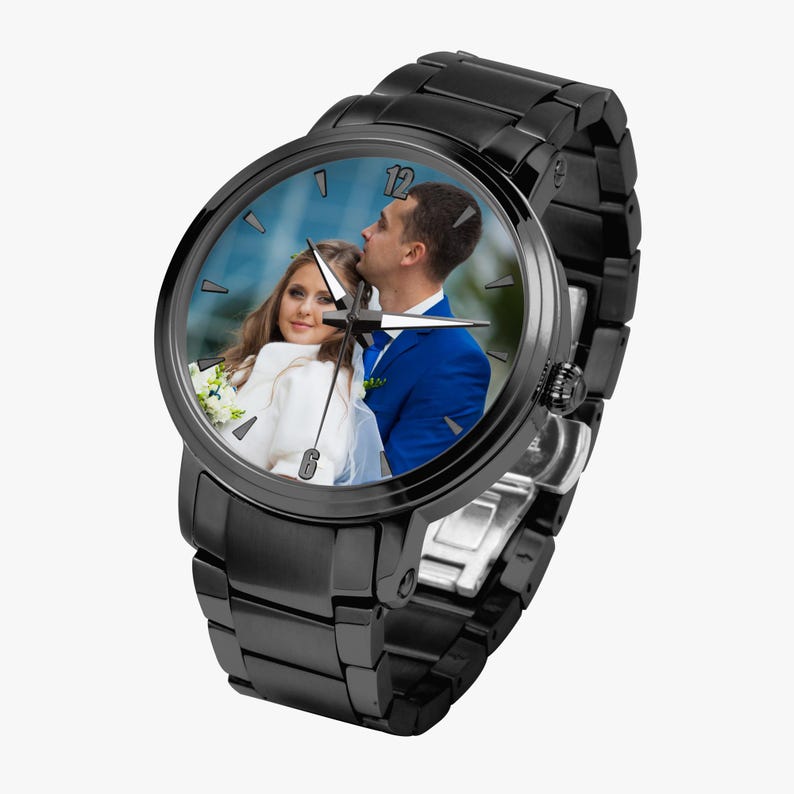 May include: Black wristwatch with a photo of a couple on the watch face. The watch has a black metal band and a round face. The photo shows a man in a blue suit and a woman in a white dress.
