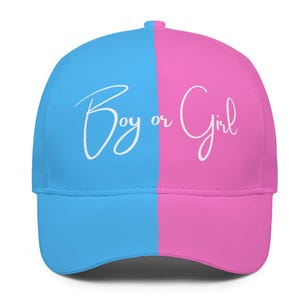May include: A blue and pink baseball cap with the text "Boy or Girl" in white cursive writing.