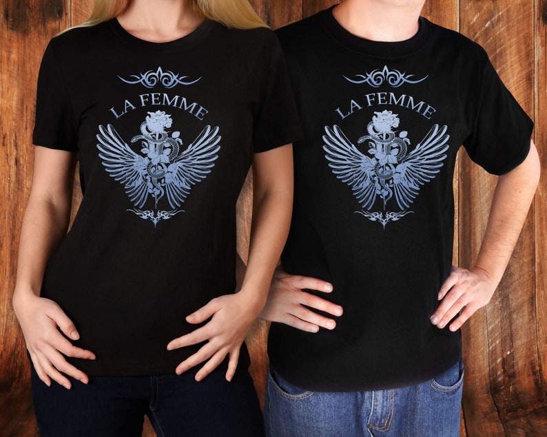 May include: Two black t-shirts with a graphic design of a rose, snake, and wings. The text "La Femme" is printed above the graphic.