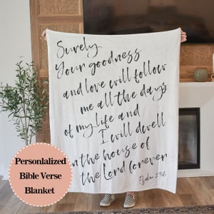 May include: White throw blanket with black text that reads "Surely your goodness and love will follow me all the days of my life and I will dwell in the house of the Lord forever." Psalm 23:6 is printed at the bottom of the blanket.