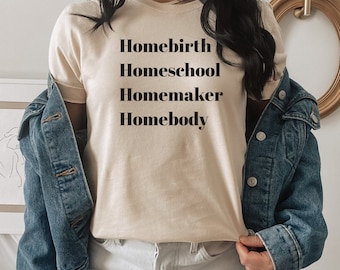 May include: A beige t-shirt with the text "Homebirth Homeschool Homemaker Homebody" printed in black.