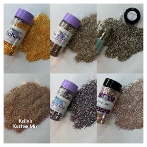 May include: Six small jars of glitter, each with a different color and a label with the name of the glitter. The labels are all in a similar style, with a purple background and white text. The glitter colors are gold, silver, pink, purple, blue, and green.