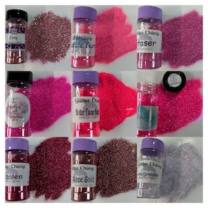 May include: Assortment of small jars filled with various colors of glitter. The jars have purple lids and labels with the text "Glitter Chimp" and the name of each glitter color. The glitter colors include:  "Nod", "Bubble Gum", "Eraser", "Sassy Pants", "Hotter Than Hot", "Azalea", "Rose Gold", and "Honey Lavender".