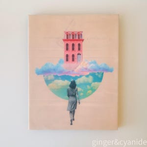 May include: A canvas print featuring a surrealist collage. A pink building floats above a semi-circle of clouds. A person in a dress walks towards the clouds. The background is a pale peach color. The text "ginger&cyanide" is in the bottom right corner.