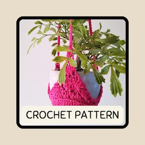 May include: A vibrant pink crochet plant hanger supporting a potted plant with green leaves. The text "CROCHET PATTERN" is displayed on a white rectangular label at the bottom of the image. The plant pot is a light gray color.