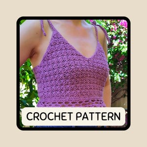 May include: A purple crochet top with a V-neck and tie straps. The top features a textured stitch pattern and a decorative openwork design at the bottom. The text "CROCHET PATTERN" is displayed at the bottom of the image.