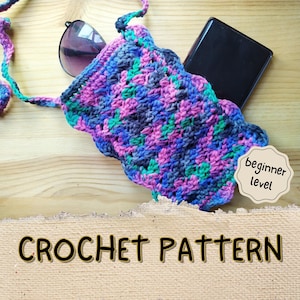 May include: A colourful crocheted phone pouch or small bag with a long strap. The pouch is made with a variety of shades of pink, blue, green, and grey yarn. The text "beginner level" is visible in the image.  CROCHET PATTERN is written in large letters on a brown background.