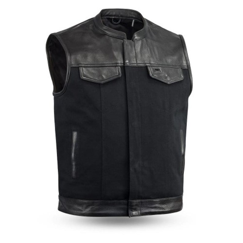May include: Black leather and denim motorcycle vest with a snap closure. The vest has a collar and two pockets.