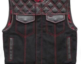 May include: Black denim vest with red stitching and a quilted leather panel. The vest has two front pockets and a paisley patterned lining.