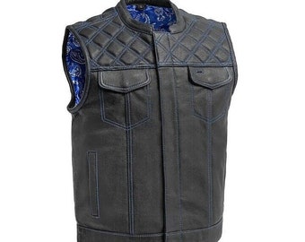 May include: Black leather motorcycle vest with blue stitching and a quilted design. The vest has a snap closure and two pockets.