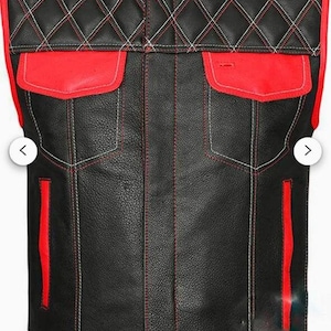 May include: Black leather motorcycle vest with red trim and diamond-shaped stitching. The vest has two pockets on the front and a zip closure.