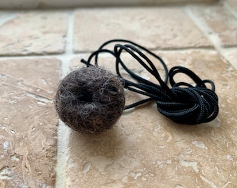 Small light pull for bathrooms, deep brown  colour mix, with black pull cord. Scandinavian, hygge decor. Handmade, rustic style. 100% wool