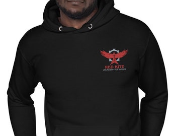 May include: Black hooded sweatshirt with a drawstring and a kangaroo pocket. The sweatshirt features a red and gray emblem on the chest with the words "RED KITE, ACADEMY OF ARMS". The design includes a stylized bird and a sword.