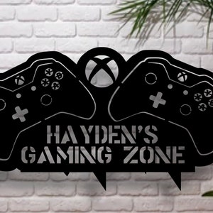 May include: Black metal sign featuring two video game controllers and the text "HAYDEN'S GAMING ZONE".