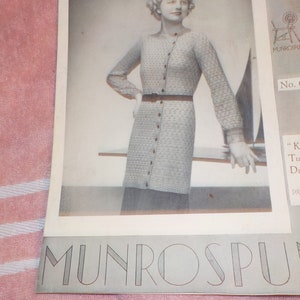 May include: A knitting pattern for a gray tunic dress called "Kyra" from Munrosun. The pattern number is 65 and the price is 2/1.