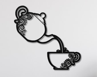 May include: Black metal wall art depicting a teapot pouring tea into a cup. The teapot and cup are decorated with intricate floral designs.