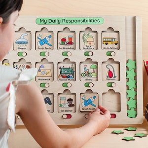 Wooden toddler routine chore chart with a built-in reward system, designed to help kids learn daily responsibilities through visual planning. Educational weekly planner for children featuring a clear, child-friendly layout that supports routine building and positive habits. A thoughtful educational gift for kids that encourages independence, motivation, and consistency.