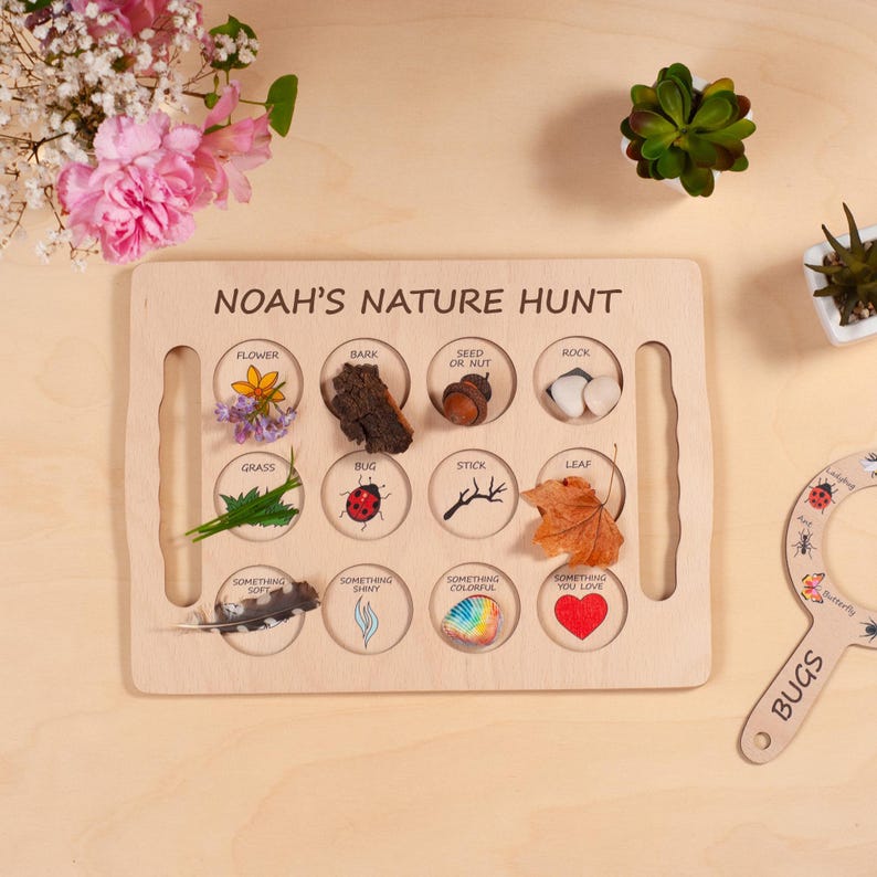 May include: A rectangular wooden nature hunt board with the text NOAH'S NATURE HUNT. It features twelve circular cutouts labeled with items like flower, bark, seed or nut, rock, grass, bug, stick, leaf, something soft, shiny, colorful, and something you love.