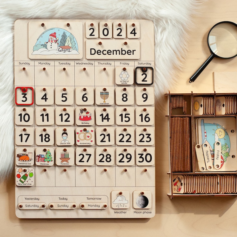May include: A wooden calendar with removable tiles for each day of December 2024. The calendar features illustrations of holidays and events, such as Christmas Eve, Hanukkah, and a birthday cake. The calendar also includes a weather icon and a moon phase icon.