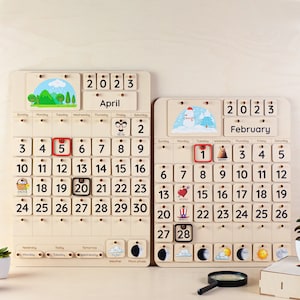 May include: Two wooden calendars, one for April and one for February, both with 2023 printed on them. The April calendar has a green hill and trees, while the February calendar has a snowman. Each calendar has a small picture for each day of the month.