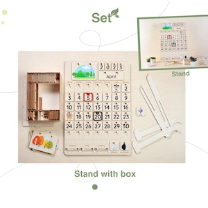 May include: A wooden calendar set with a stand and a box of numbered tiles. The calendar features a simple design with a light wood finish and a white background. The calendar is labeled "2023 April" and has a grid of numbers from 1 to 30. The stand is made of wood and has a simple design. The box of numbered tiles is made of wood and has a light wood finish.