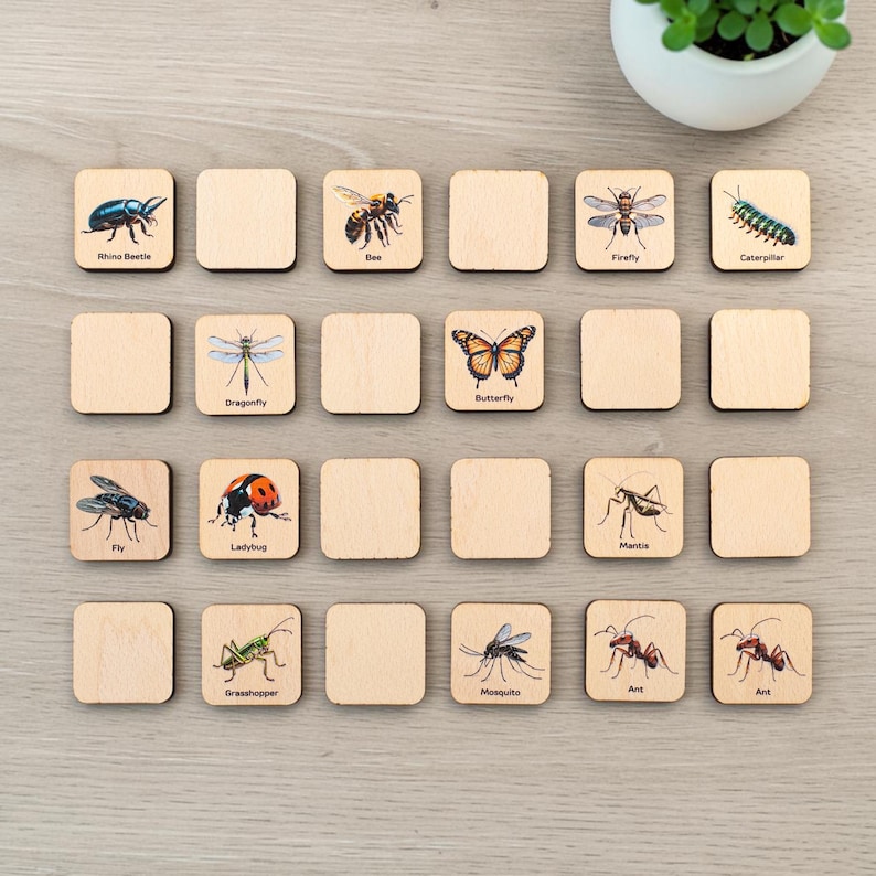 May include: A set of square wooden tiles featuring illustrations of various insects including a rhino beetle, bee, firefly, caterpillar, dragonfly, butterfly, fly, ladybug, mantis, grasshopper, mosquito, and two ants, each labeled with its name.