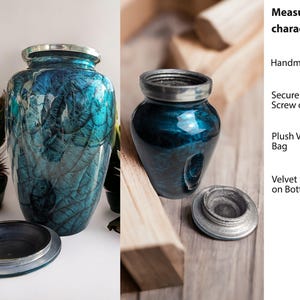 May include: Two urns with a blue and teal marbled design and silver trim. One urn is tall and cylindrical, the other is shorter and round. The lids are off, revealing the openings. The urns are handmade and have a secure screw-on lid.