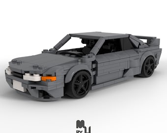 May include: A gray Lego model of a Nissan Skyline GT-R R32, a popular Japanese sports car.