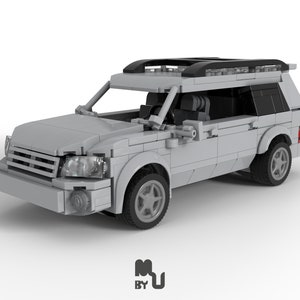May include: A grey Lego model of an SUV with a black roof rack. The car has black wheels and a detailed interior.