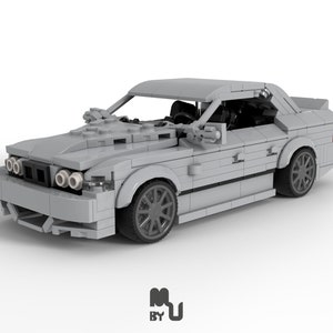 May include: A grey Lego model of a car with black accents and detailed headlights. The car is built in a realistic style and features a sleek design.
