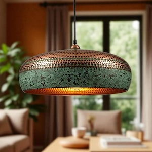 May include: A dome-shaped pendant light fixture featuring a hammered copper finish on the upper section and a textured, weathered green patina on the lower portion. The interior of the metal shade is finished in a warm, reflective copper tone.