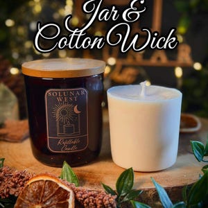 May include: A dark amber glass candle jar with a wooden lid and a Solunar West label, accompanied by a white wax refill insert featuring a cotton wick. The label displays a sun and moon graphic with the text Solunar West Refillable Candle.