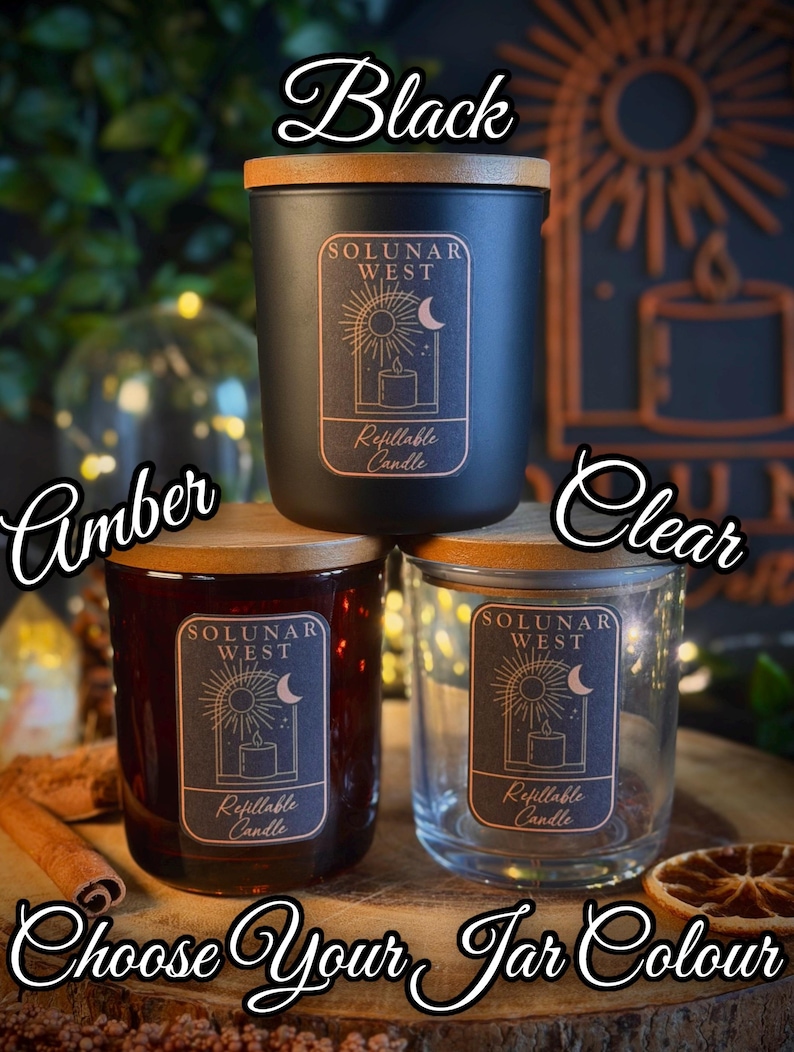 May include: Three refillable candle jars with wooden lids, labeled Solunar West. The jars come in black, amber, and clear glass. Each jar features a rectangular label with a sun and moon graphic. The text reads Choose Your Jar Colour.