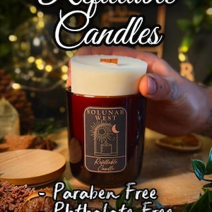 May include: A refillable candle in a dark amber glass jar with a wooden wick. The label features the text Solunar West, Refillable Candle, and a sun and moon graphic. The text Refillable Candles, Paraben Free, Phthalate Free, and Cruelty Free is present.