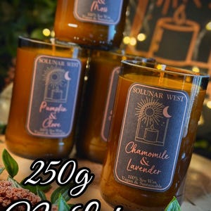 May include: Several glass jar candles with labels that read "Cedarwood & Moss", "Pumpkin & Clove", and "Chamomile & Lavender". The candles are 250g and made with 100% soy wax. The text "No Lid" is also visible.