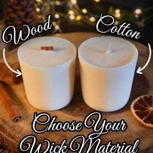 May include: Two cylindrical white candles, one featuring a flat wooden wick and the other a braided cotton wick. Text on the image reads: Wood, Cotton, and Choose Your Wick Material. The candles are presented side by side for comparison.