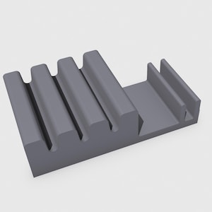May include: Gray plastic phone stand with a built-in holder for multiple phones or other devices.