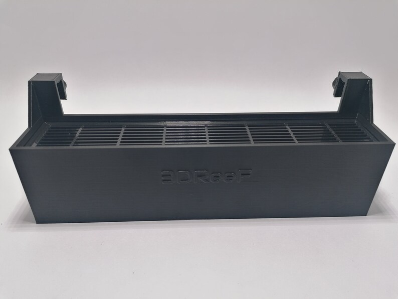 May include: Black plastic 3D printer fan duct with a grid pattern and the word "3DREF" printed on the front.