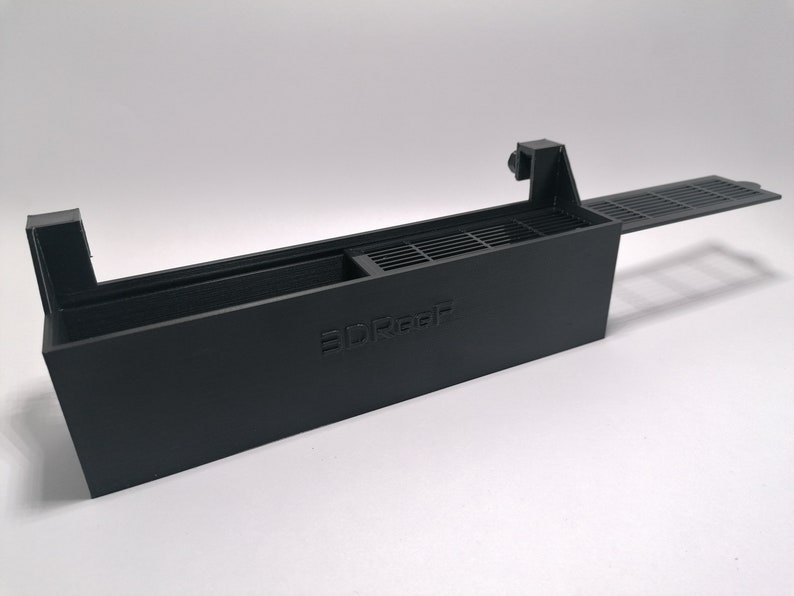 May include: A black plastic 3D printed filter holder with a removable lid and a grate. The holder has the word "3DReef" printed on the side.