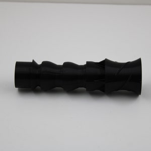 May include: A black plastic nozzle with a spiral design. The nozzle is approximately 15 cm long and has a diameter of about 2.5 cm.