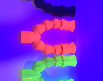 May include: Three flexible, articulated tubes in black, orange, and green. Each tube has a cylindrical base and a ribbed, bendable body. The background is a gradient of blue and purple.