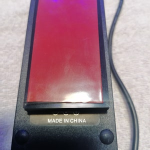 May include: Black power adapter with a red sticker and the text "MADE IN CHINA" on the bottom.