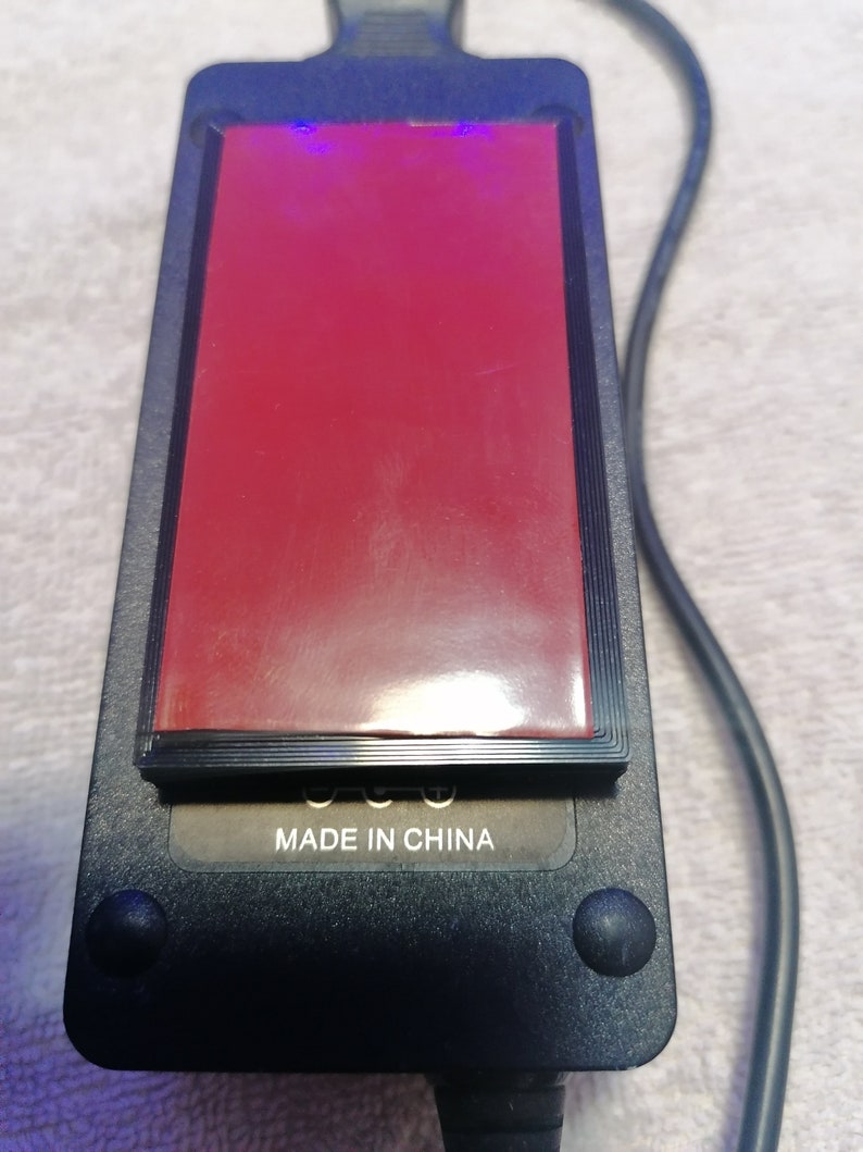 May include: Black power adapter with a red sticker and the text "MADE IN CHINA" on the bottom.